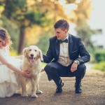 Bride and groom with their pet dog.
